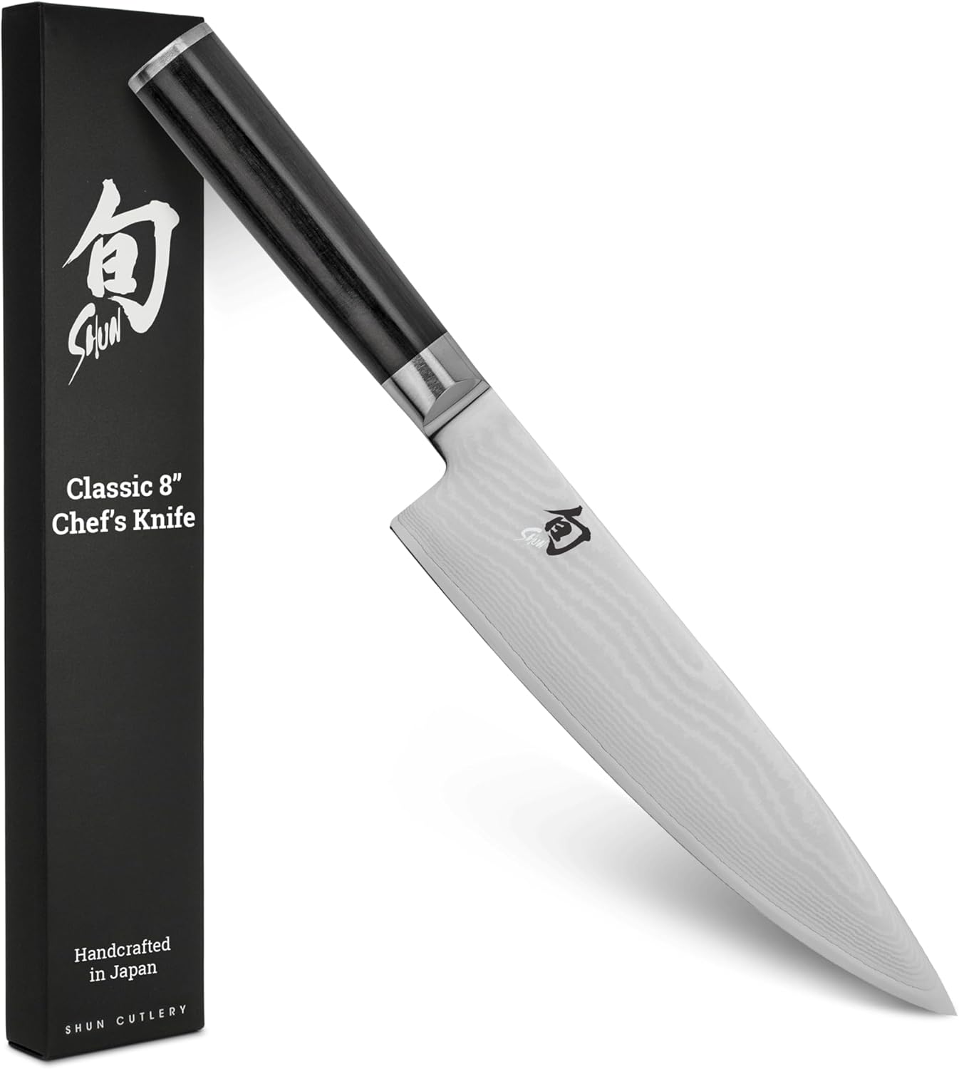 Shun Classic 8-inch chef's knife with Damascus-clad blade and black D-shaped PakkaWood handle next to its gift box, handcrafted in Japan