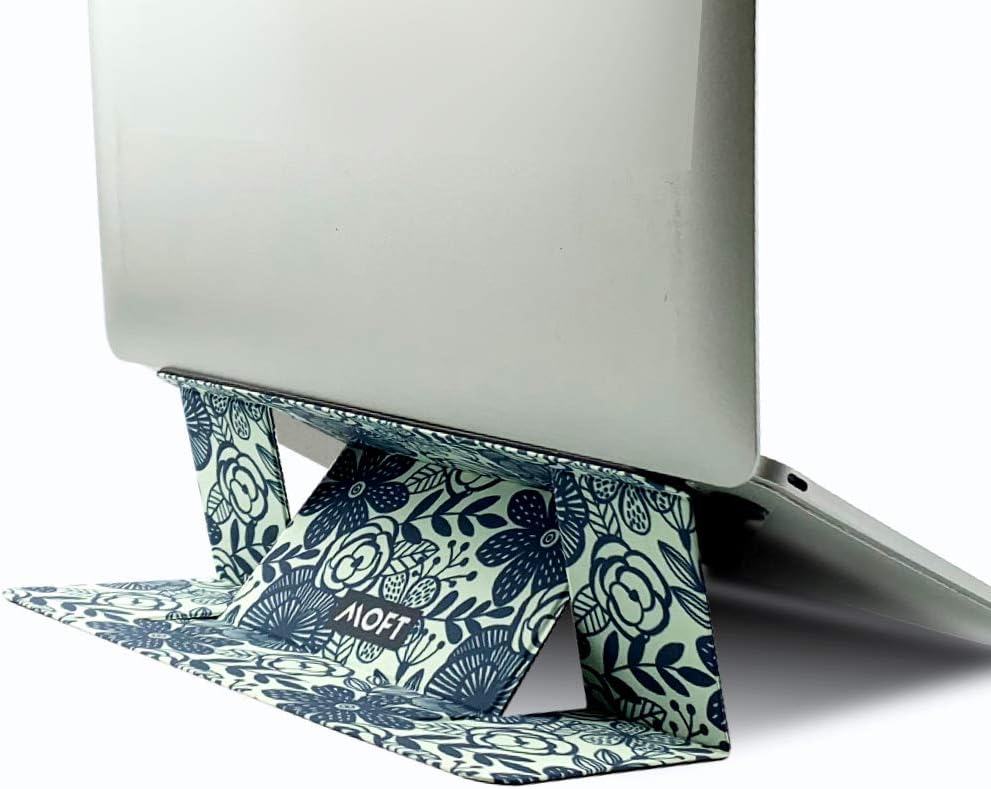 MOFT Invisible slim laptop stand in space grey folded into its raised typing angle, attached to the underside of a laptop