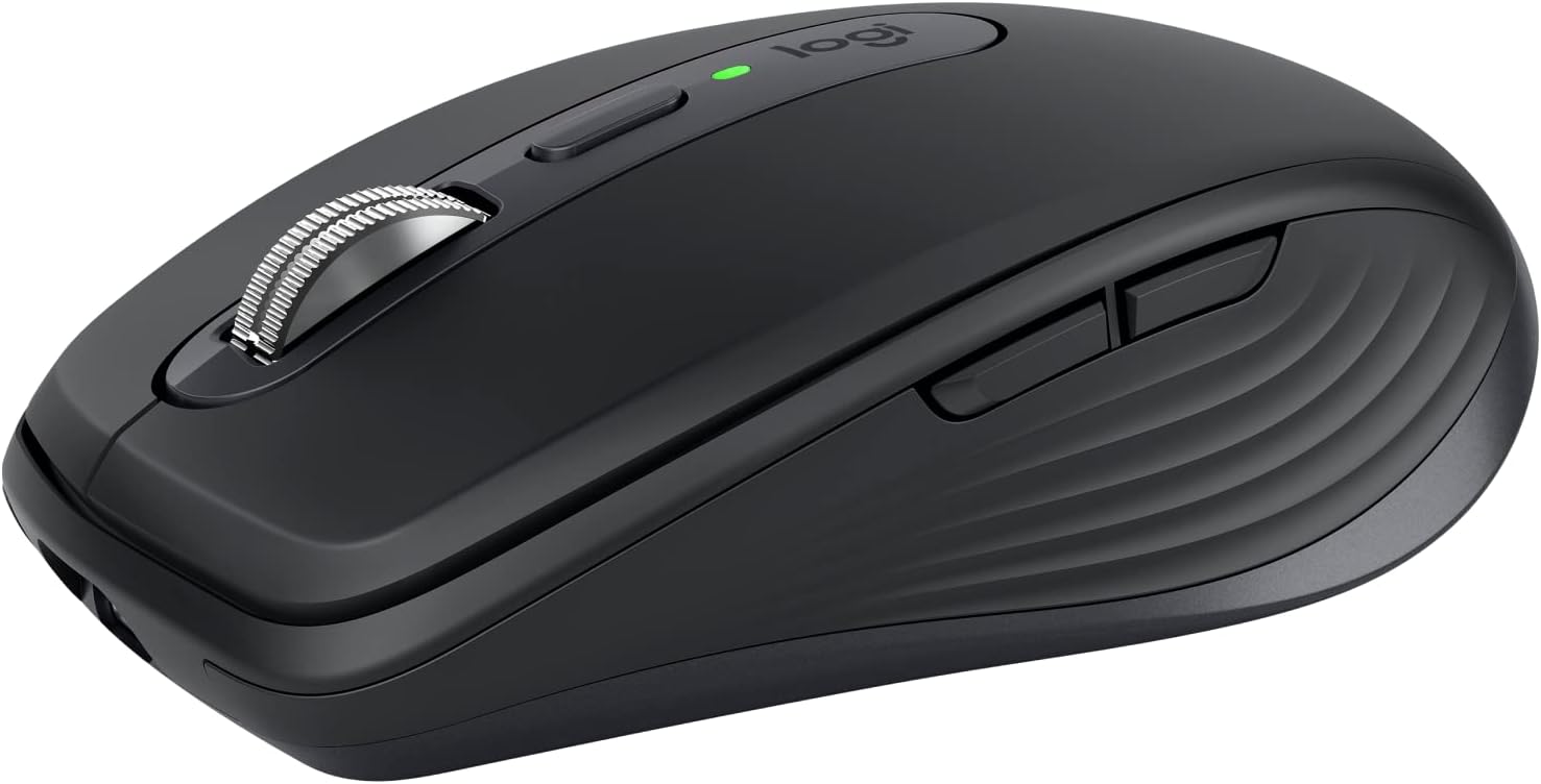 Logitech MX Anywhere 3S compact travel mouse with metal scroll wheel beside a laptop