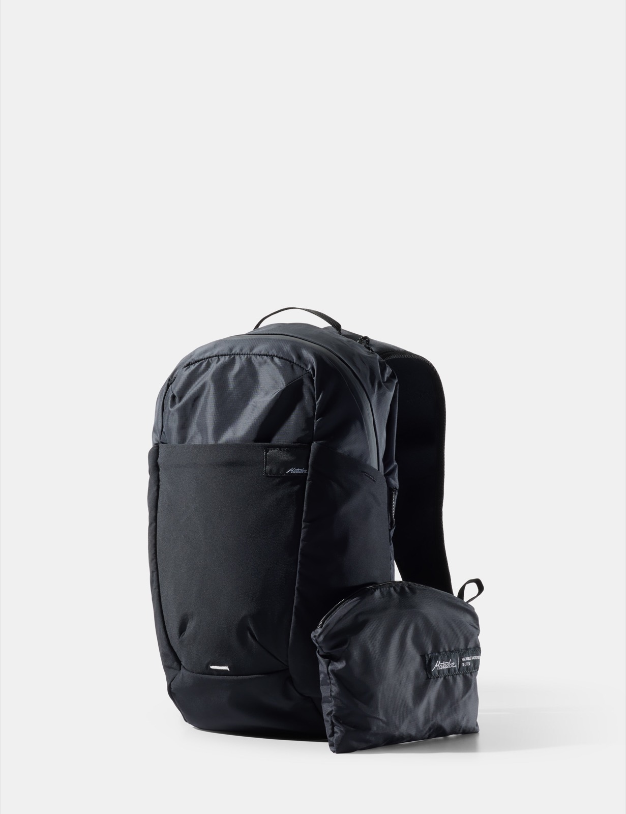 Matador ReFraction Packable Backpack 16L travel backpack in black with slim profile, front stretch pocket, and padded shoulder straps