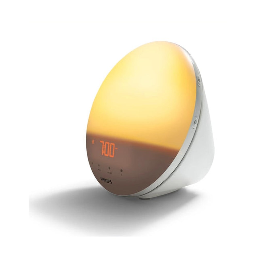 Philips SmartSleep Wake-up Light HF3520/60 domed sunrise alarm lamp glowing warm yellow with 7:00 display and white base